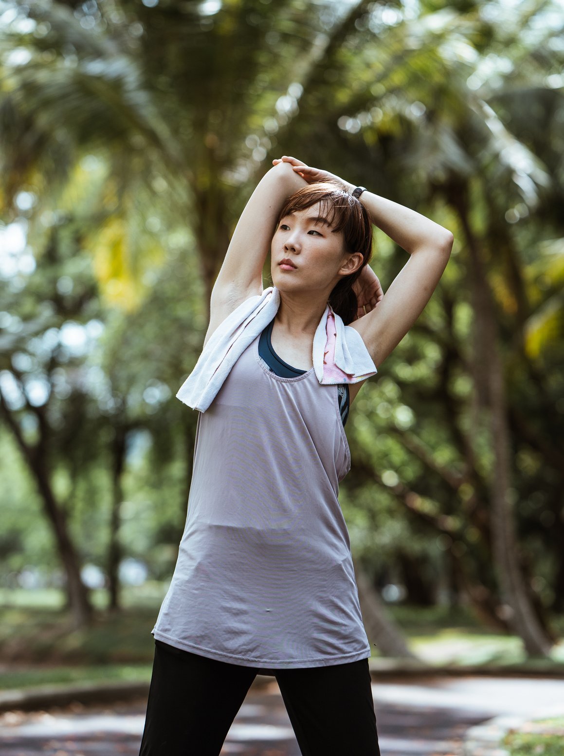 Young Asian woman warming up before exercising